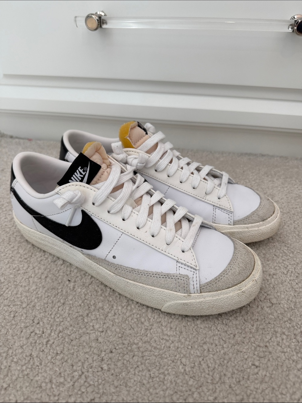 Nike White Sneakers with Black Swoosh and Yellow Tongue Accent